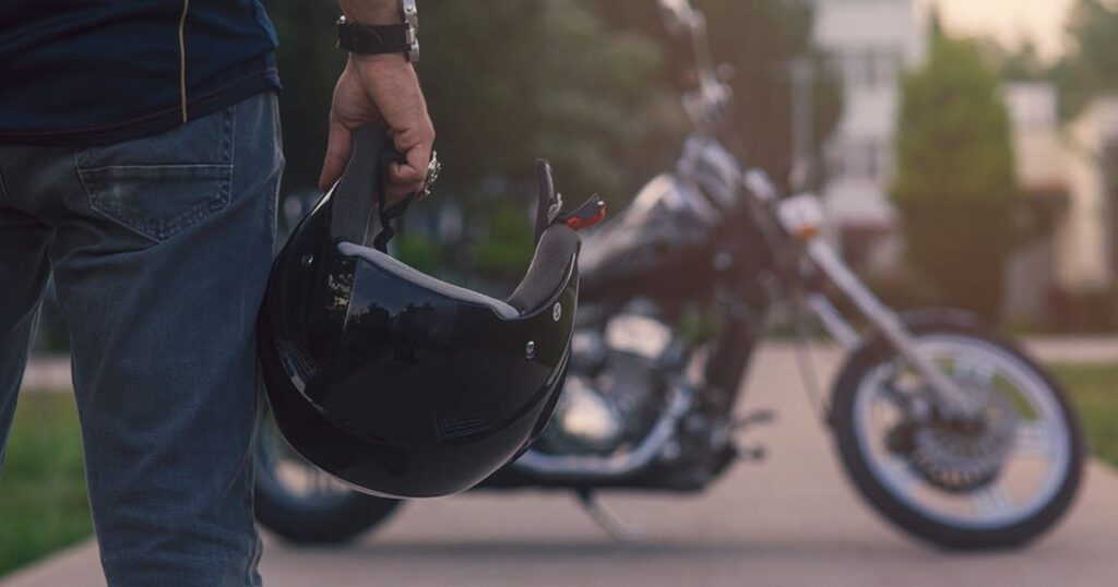 motorcycle rider holding a helmet
