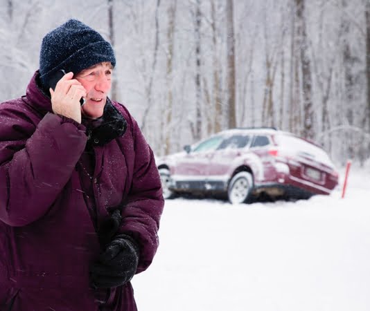 person in the snow on the phone